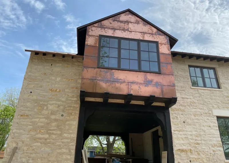 Copper metal panel facade on a stone building for Skylight Installation in Dyer